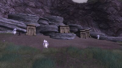 Tombs nestled beneath a rocky ridge