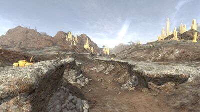 The riverbed's banks can still be seen looming over the landscape below.