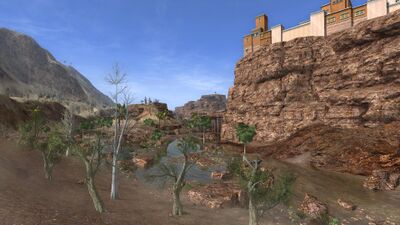 As the river passes beneath the shadow of Nizukhûr, larger remnant pools of water provide enough sustenance for some trees, shrubsm and palms.