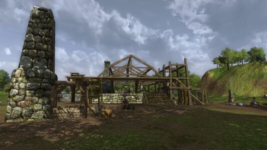 Forge with workers building in the background